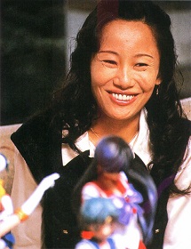 Naoko looking over some Sailor Moon statuettes